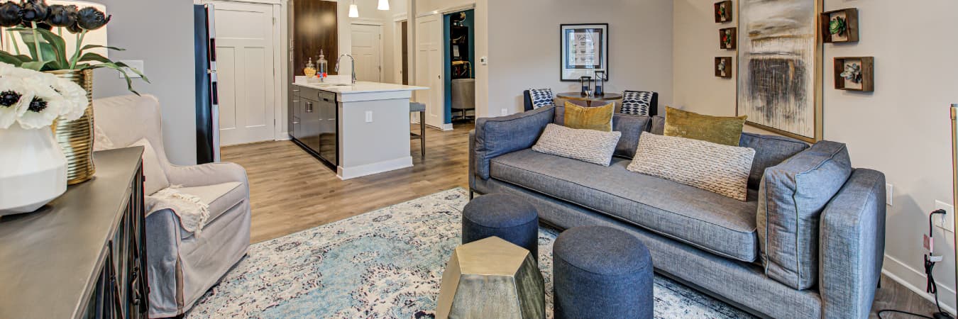 Open-concept apartment living space with a view into the kitchen.