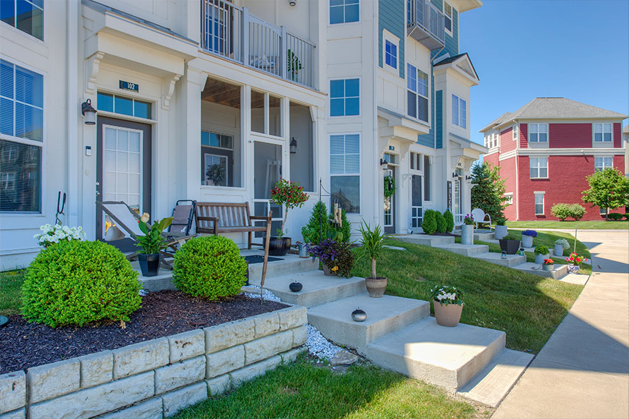 First-level patio porch with steps located at District at Saxony.